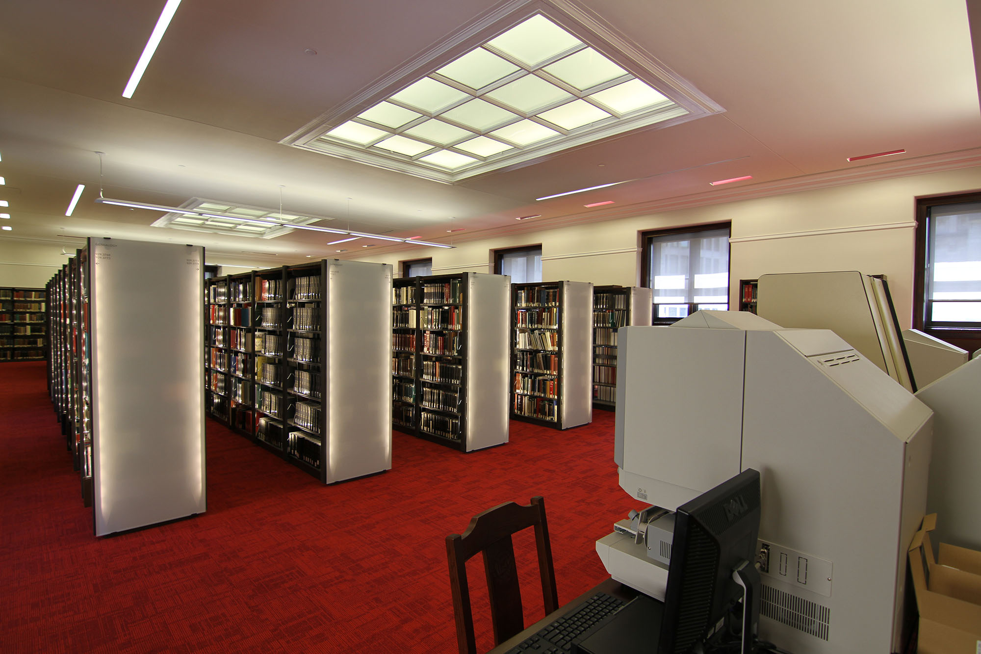 Library shelving with backlit acrylic end panels