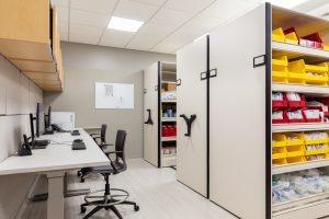 high-density mobile shelving with bins to hold healthcare equipment